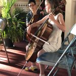 String instructor Jenny Huang-Dale watches as a young girl performs on her cello